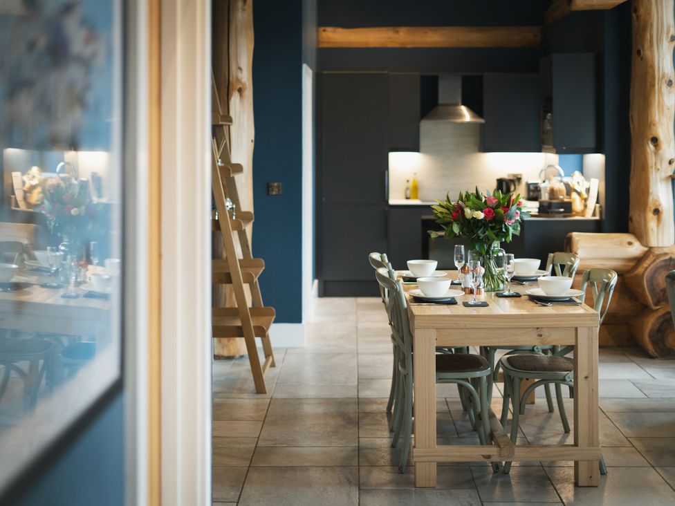 A kitchen with a dining table and chairs at The Farmhouse in Addingham