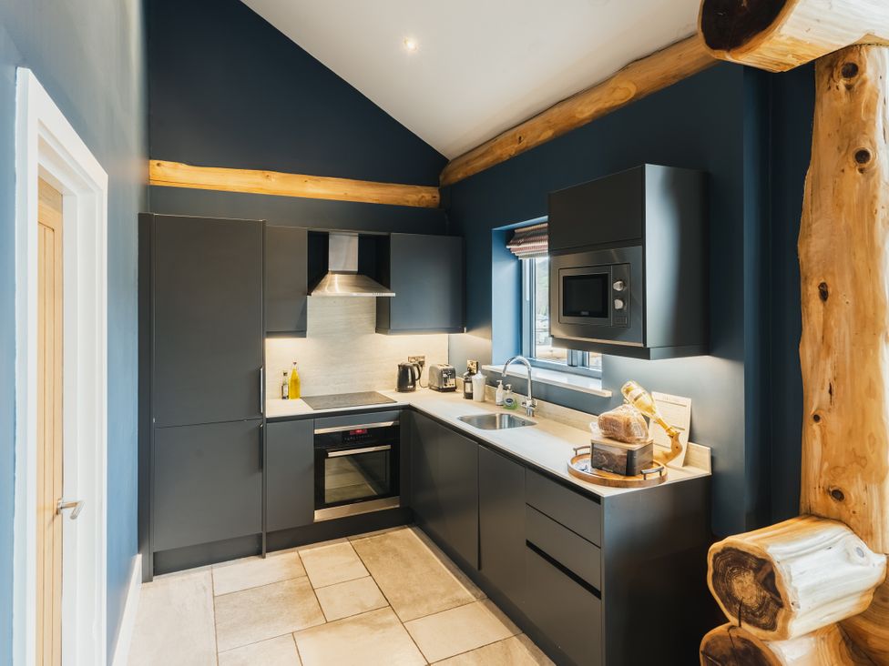 A kitchen with cabinets and a sink at The Farmhouse in Addingham