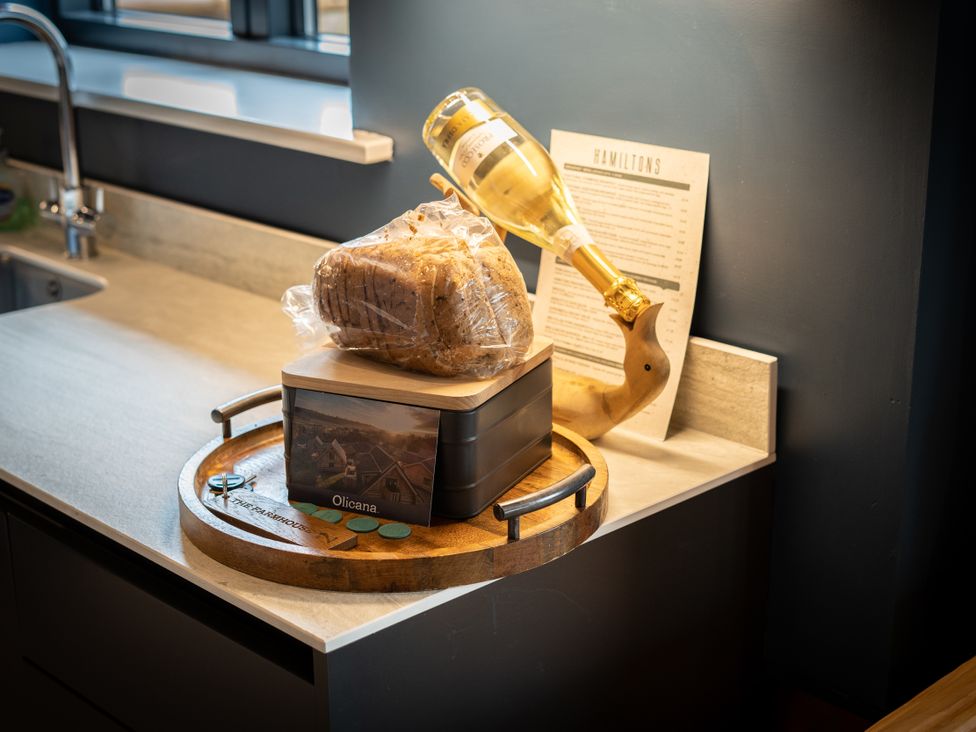 A tray with bread and a champagne bottle at The Farmhouse in Addingham