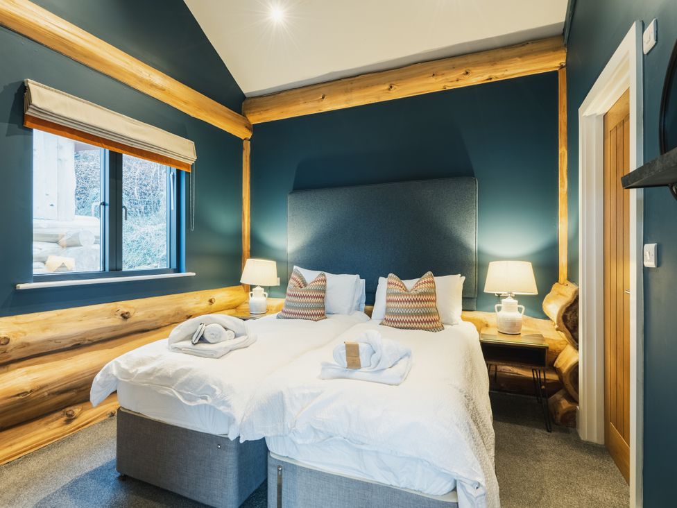 A bedroom with two beds and a window at The Farmhouse in Addingham