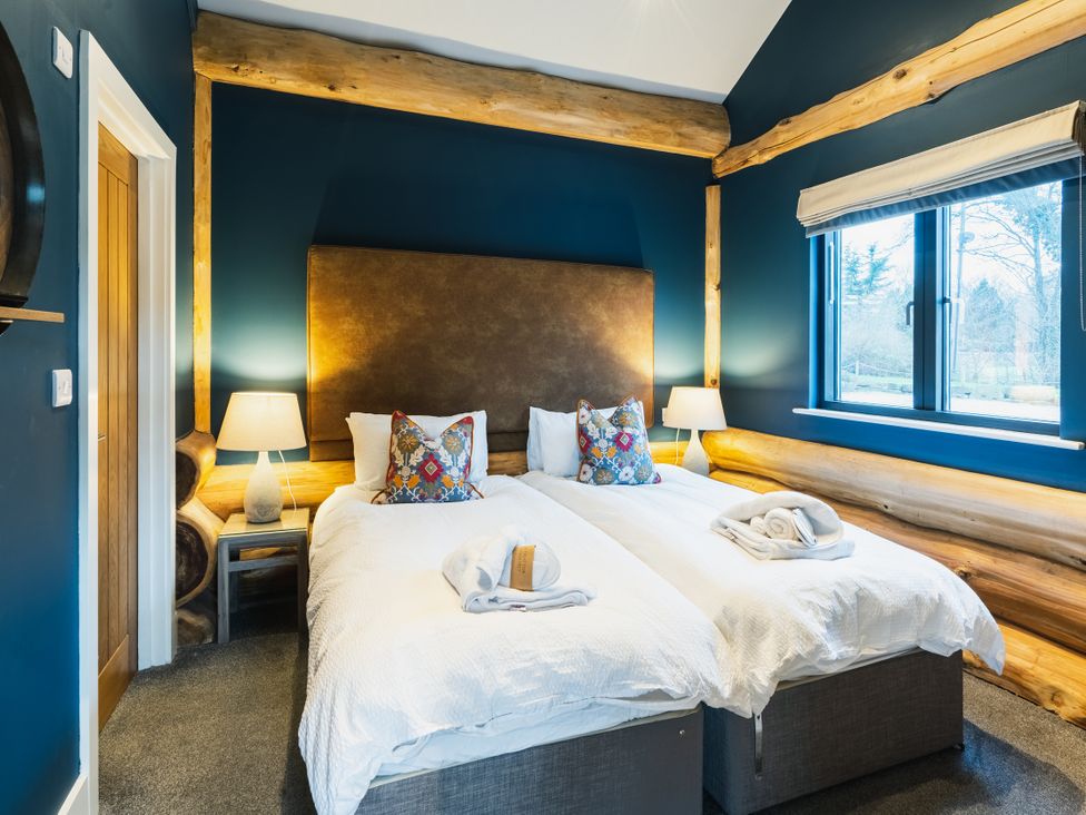 A bedroom with two beds and a window at The Farmhouse in Addingham