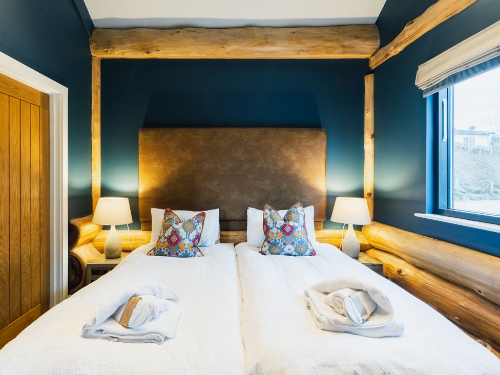 A bedroom with a bed and lamps at The Farmhouse in Addingham