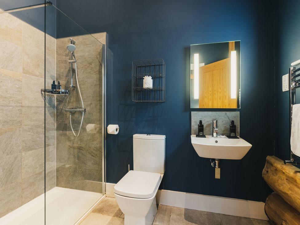 A bathroom with a shower, toilet, and sink at The Farmhouse in Addingham