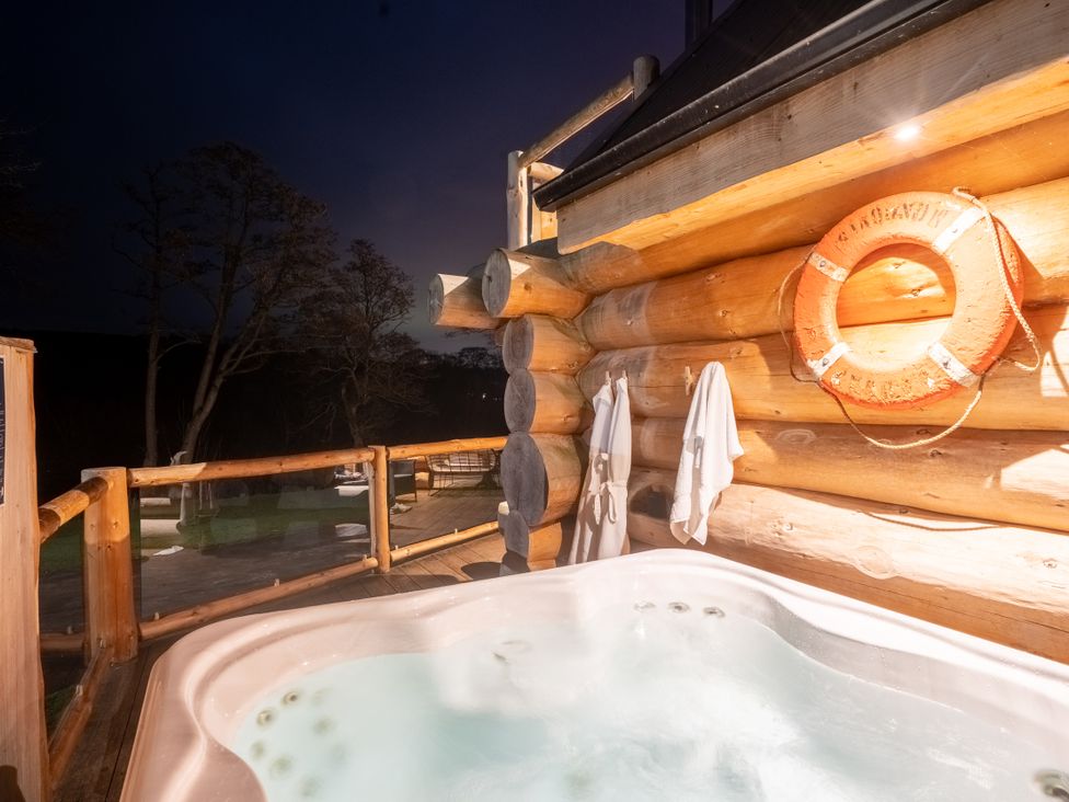 A hot tub with towels and a life ring on a deck at The Farmhouse in Addingham