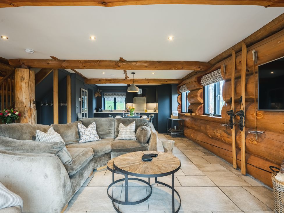 A living room with a sofa and television at Apres Ski in Addingham