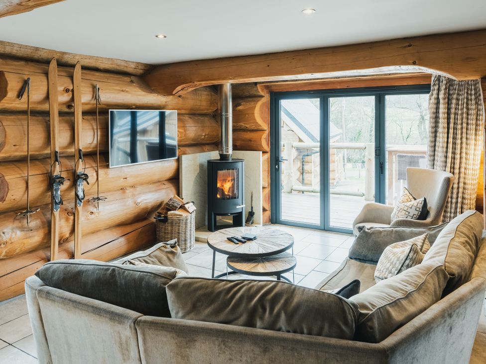 A living room with a fireplace and a sofa at Apres Ski in Addingham