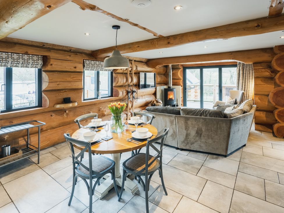 A kitchen with dining table and sofa at Apres Ski in Addingham