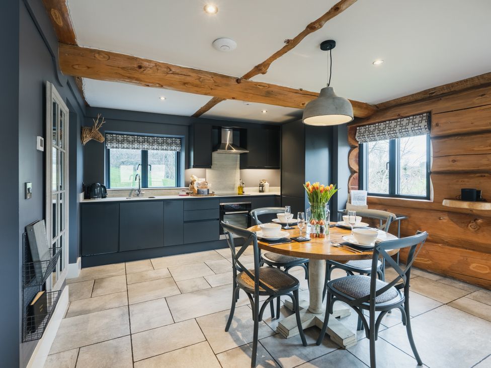 A kitchen with a table and chairs at Apres Ski in Addingham