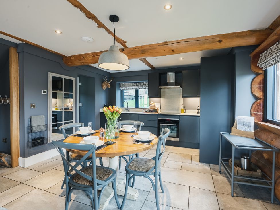 A kitchen with a table and chairs at Apres Ski in Addingham