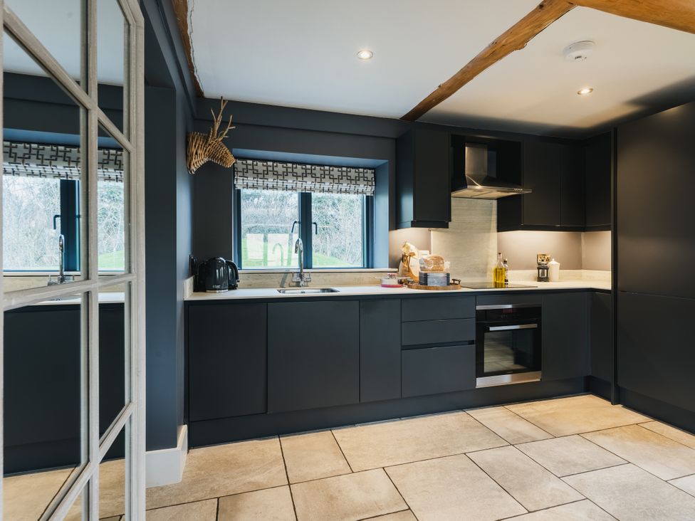 A kitchen with a sink and cooker at Apres Ski in Addingham