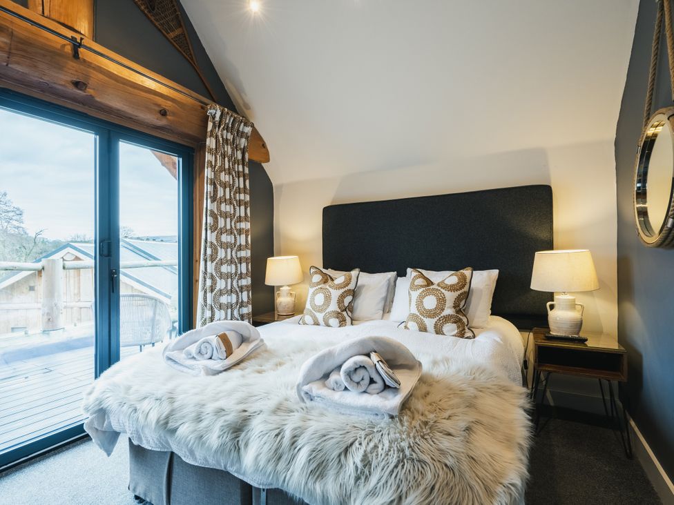 A bedroom with a bed and side table at Apres Ski in Addingham