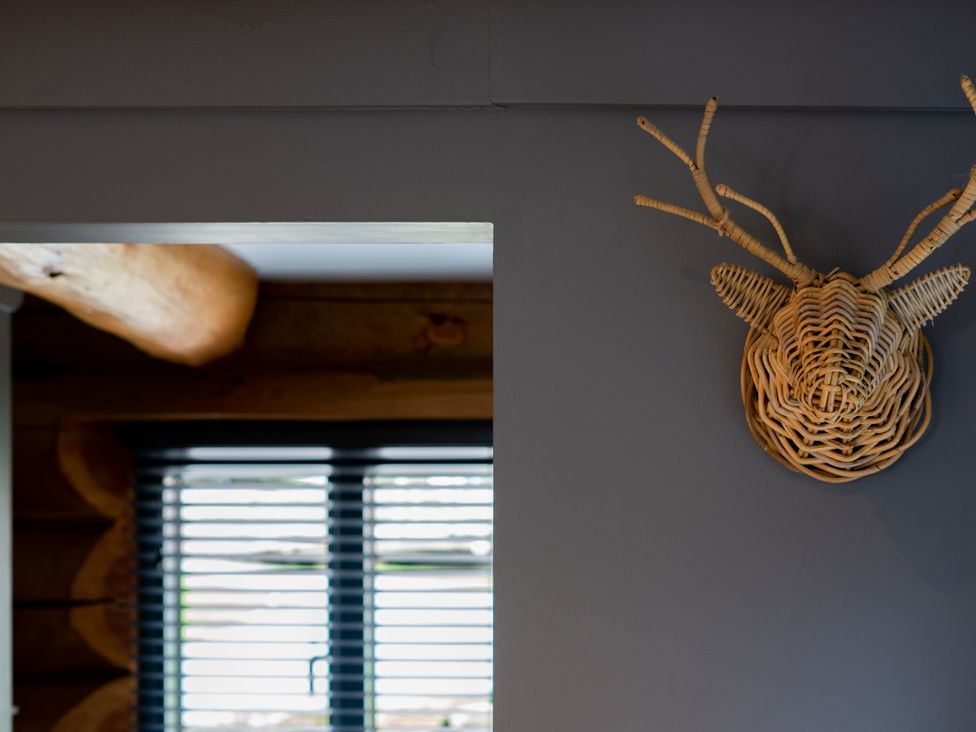 A decorative wall mount and window in a room at Apres Ski in Addingham