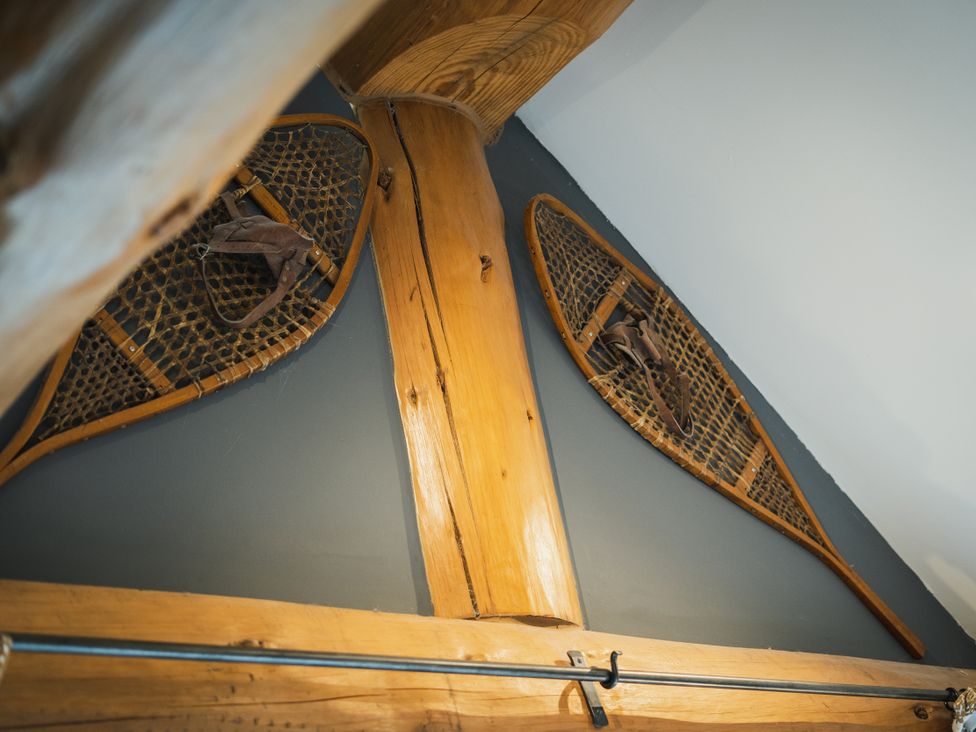 Snowshoes mounted on a wall near wooden beams at Apres Ski in Addingham
