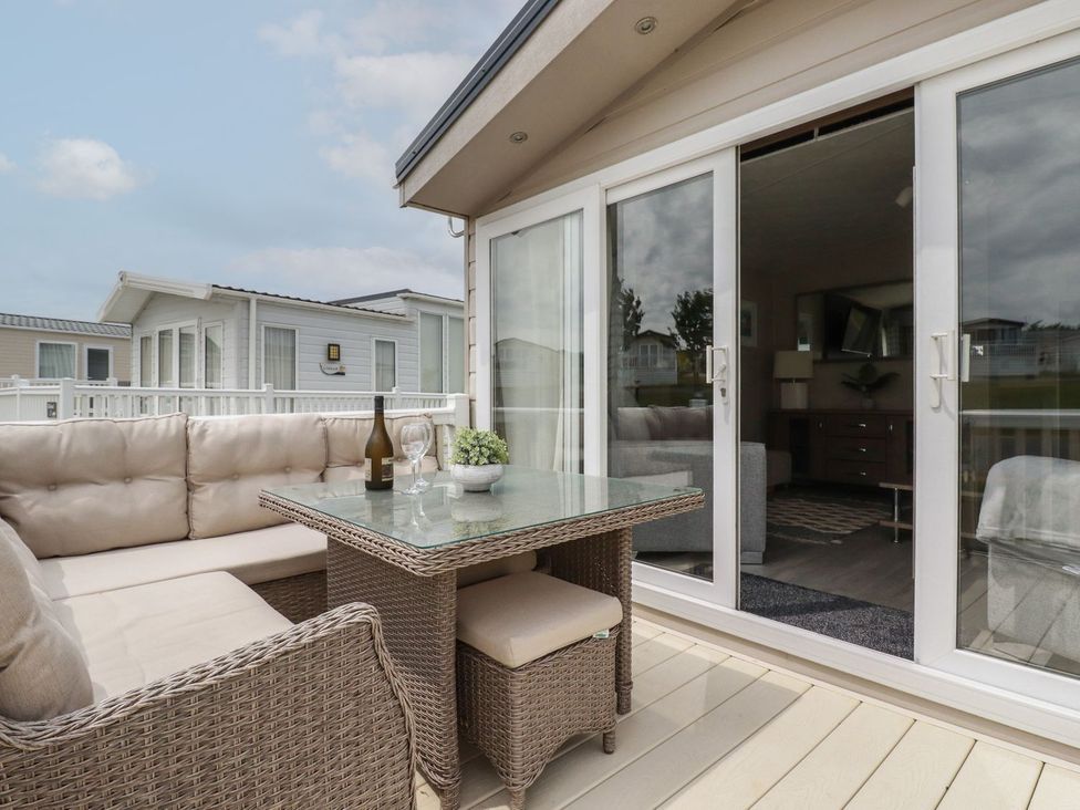 An outdoor seating area with a sofa and table at No. 4 Fistral in Newquay