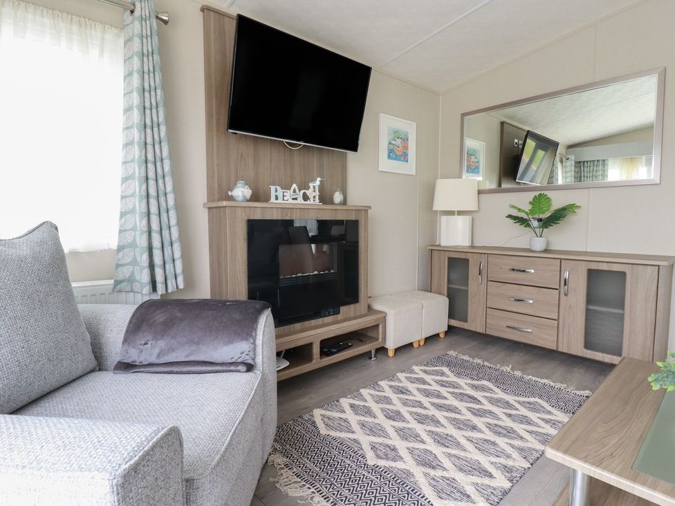 A living room with a television and a sofa at No. 4 Fistral in Newquay