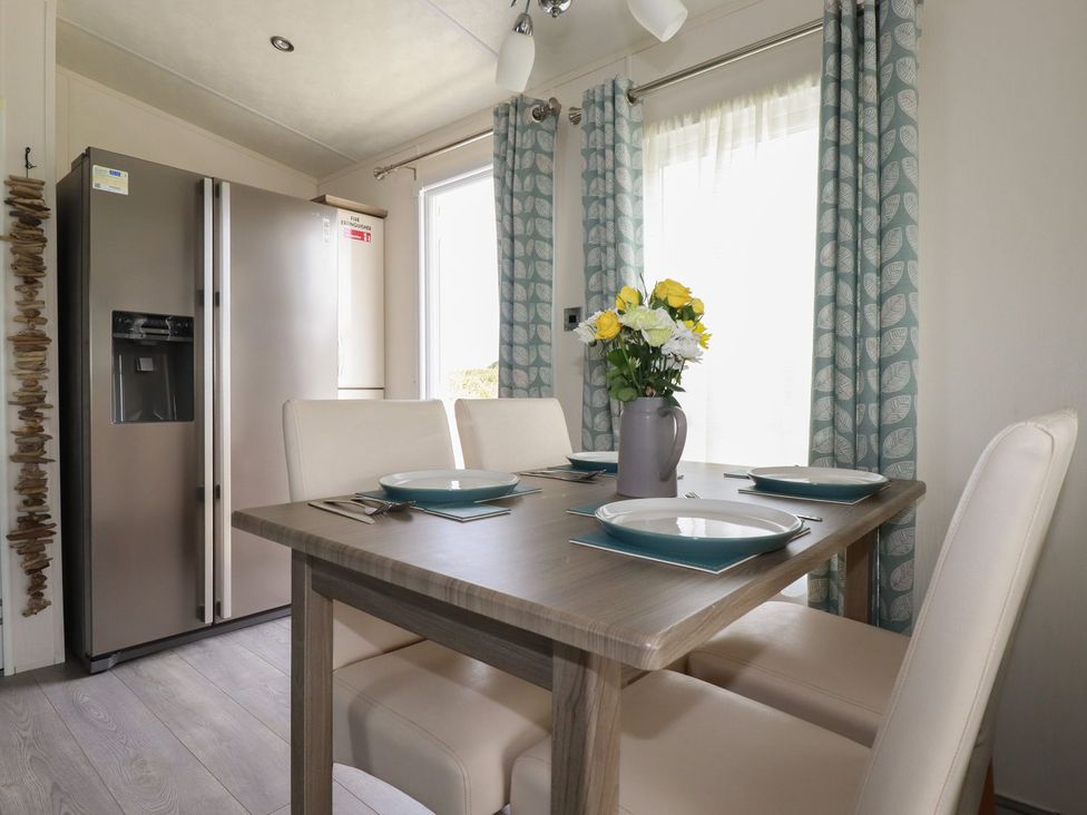 A dining room with a table and chairs at No. 4 Fistral in Newquay