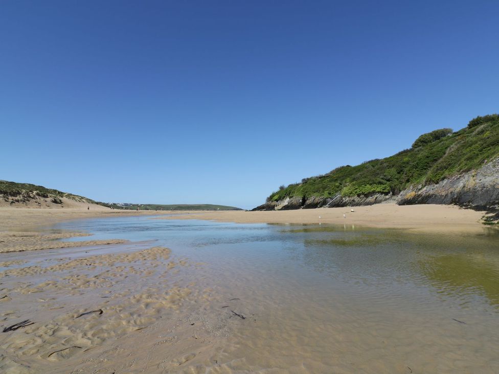 A beach with water and sand at No. 4 Fistral Newquay