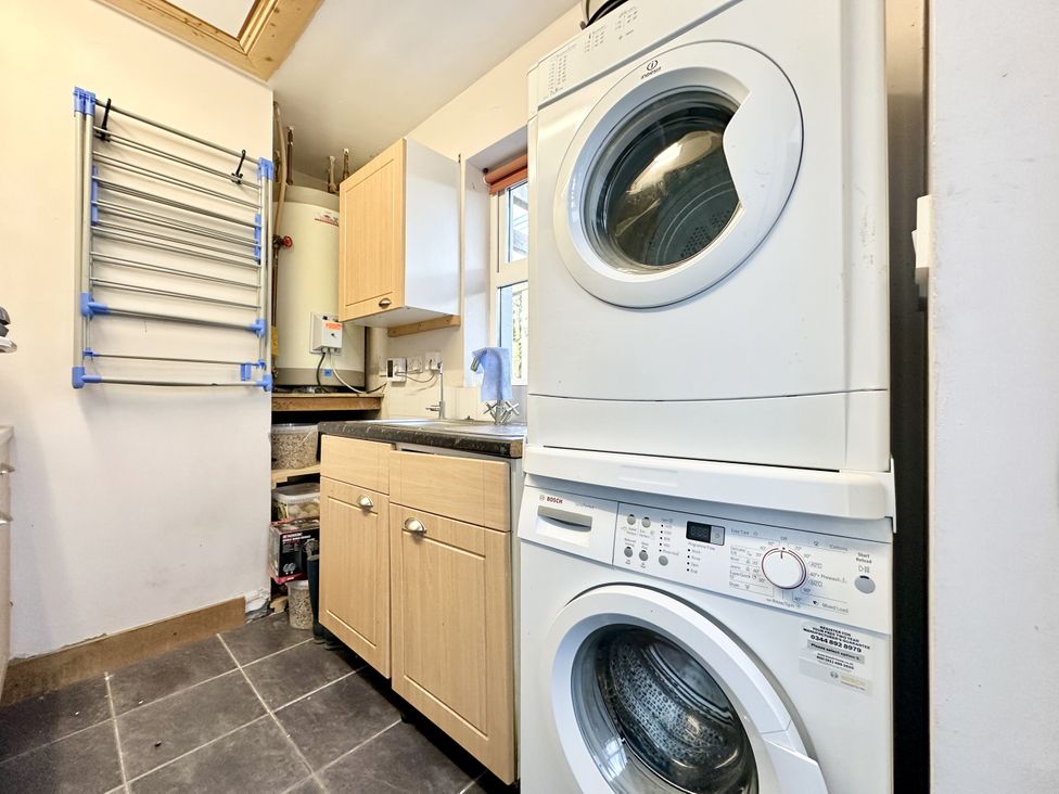 A utility room with a washing machine and tumble dryer at Seeview in Charleville