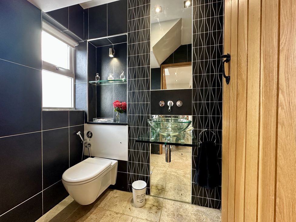 A bathroom featuring a toilet, sink, and mirror at Seeview in Charleville