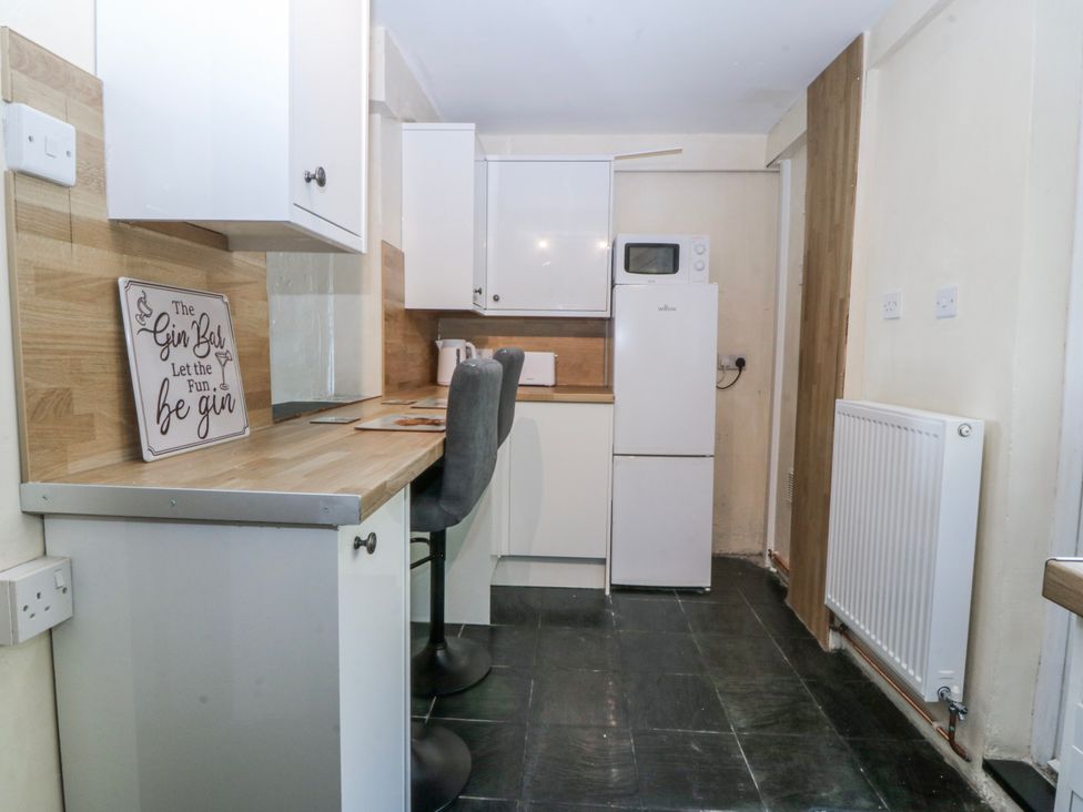 A kitchen with a bar sign and appliances at Tegfan in Garndolbenmaen near Porthmadog