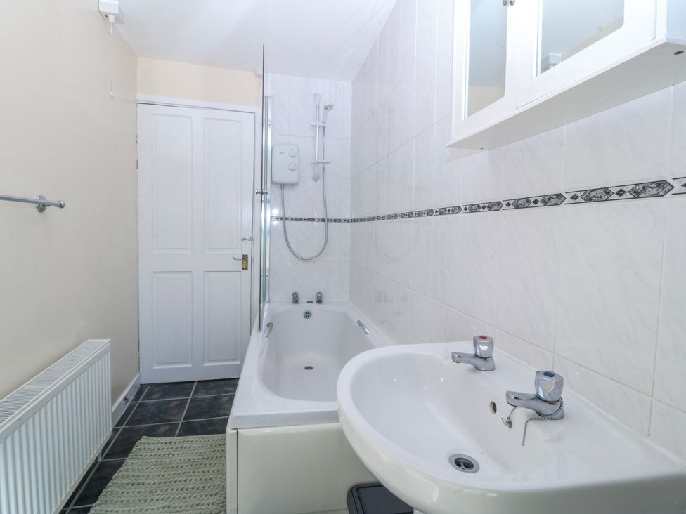 A bathroom with a bathtub and shower at Tegfan near Porthmadog