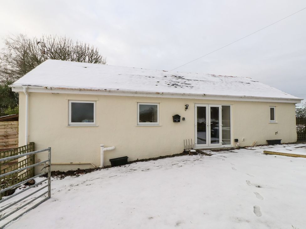 A house exterior with snow at Swallow Cottage in Llangefni