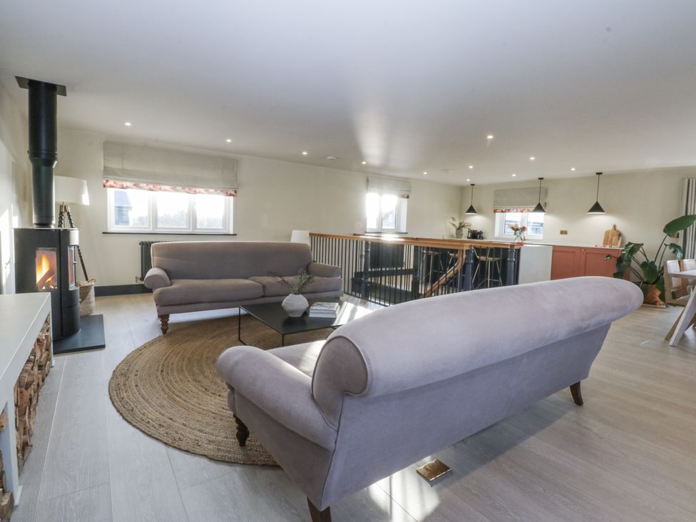 A living room with a sofa and coffee table at Bell House in Llanfechell