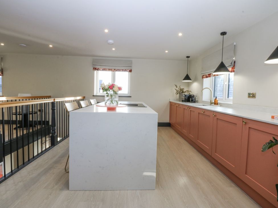 A kitchen with island and appliances at Bell House in Llanfechell