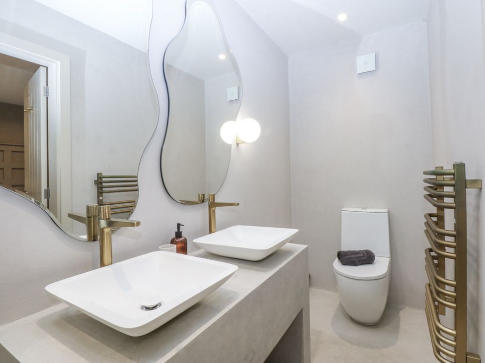 A bathroom with wash basin and toilet at Bell House in Llanfechell