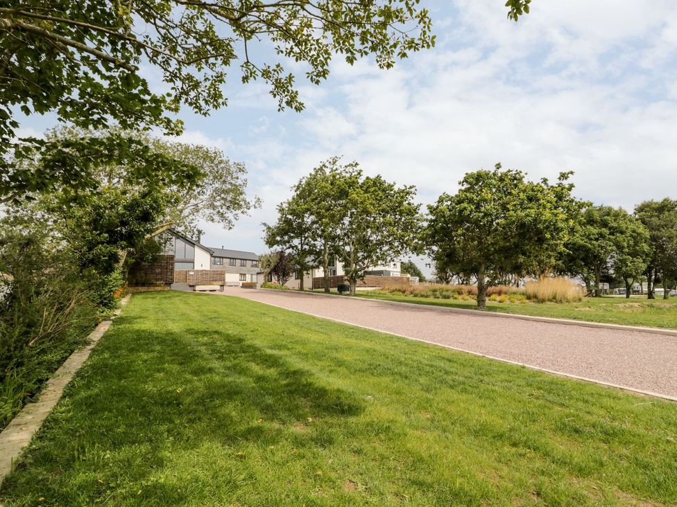 An outdoor area with trees and a pathway at Bell House in Llanfechell