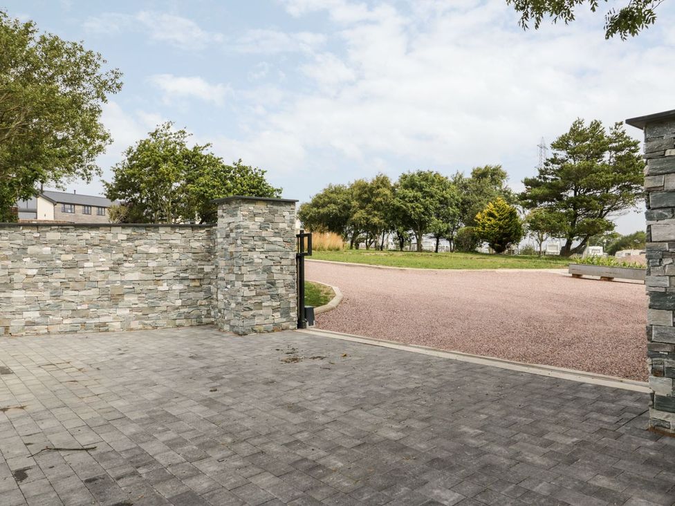 An outdoor area with a stone wall and gate at Bell House in Llanfechell