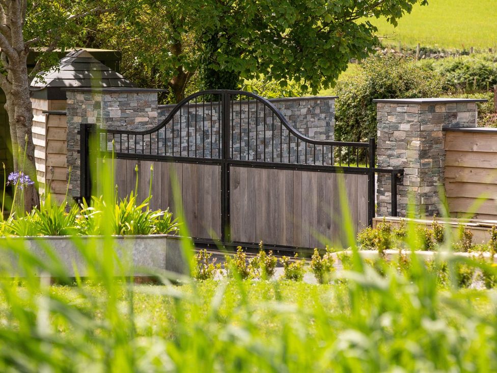 A garden with a gated entrance at Bell House in Llanfechell