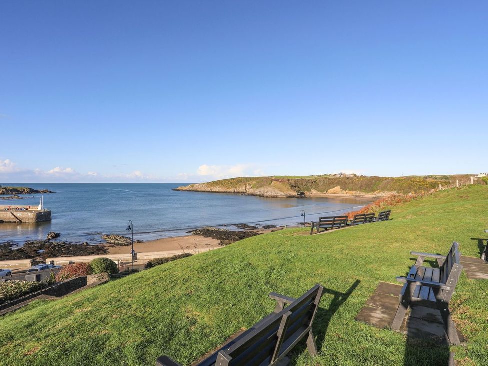 A beach with benches and sea at Bell House in Llanfechell