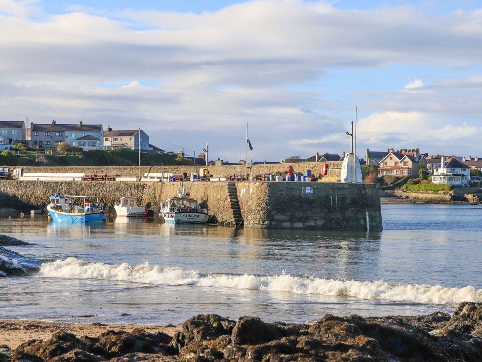 Boats at a pier with houses in the background at Bell House Llanfechell