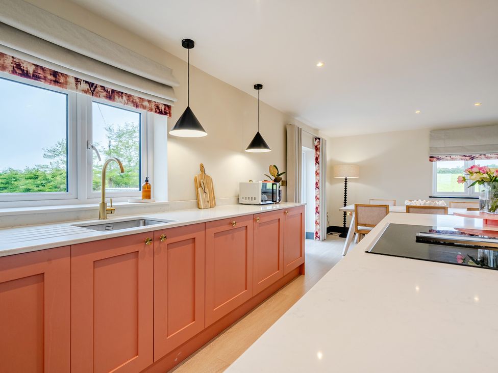 A kitchen with a sink and cabinets at Bell House in Llanfechell