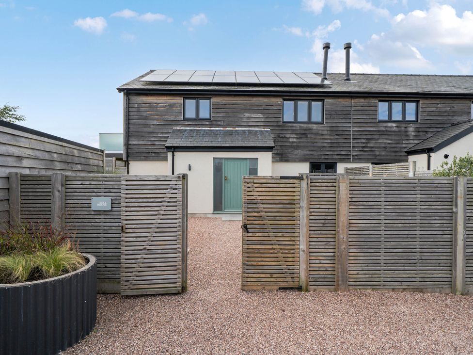 A house with gates and gravel pathway at Bell House in Llanfechell