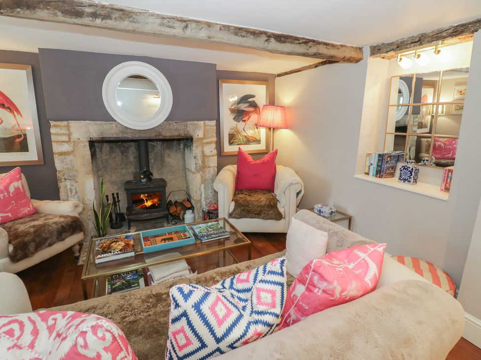 A living room with a fireplace and sofas at 23 New Church Street, Tetbury