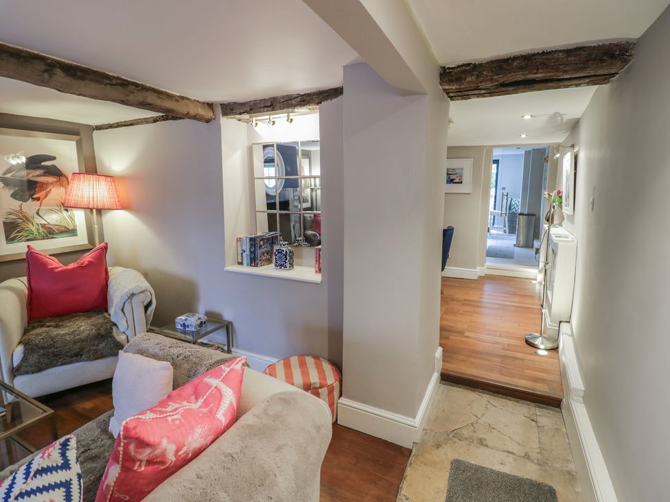 A living room with a sofa and lamp at 23 New Church Street Tetbury