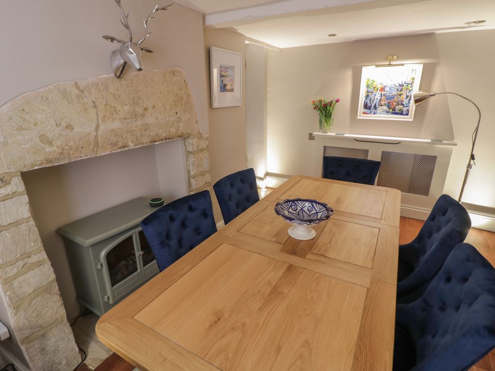 A dining room with a table and chairs at 23 New Church Street Tetbury