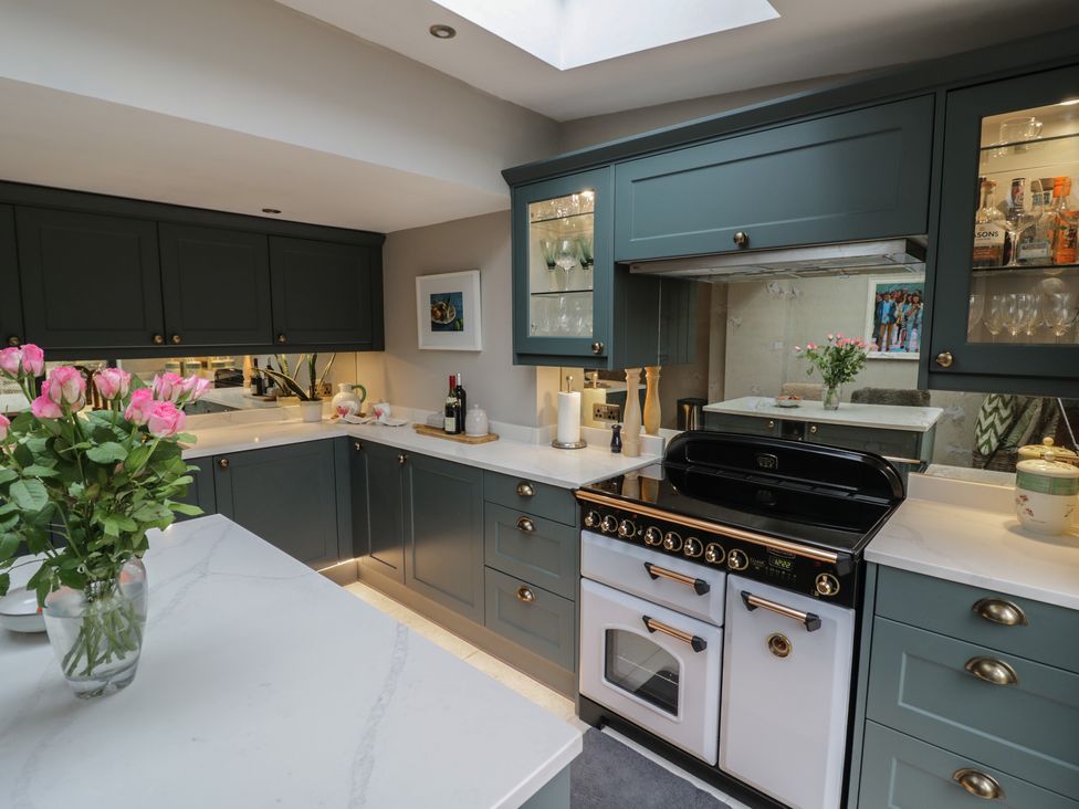 A kitchen with cabinets and a cooker at 23 New Church Street in Tetbury