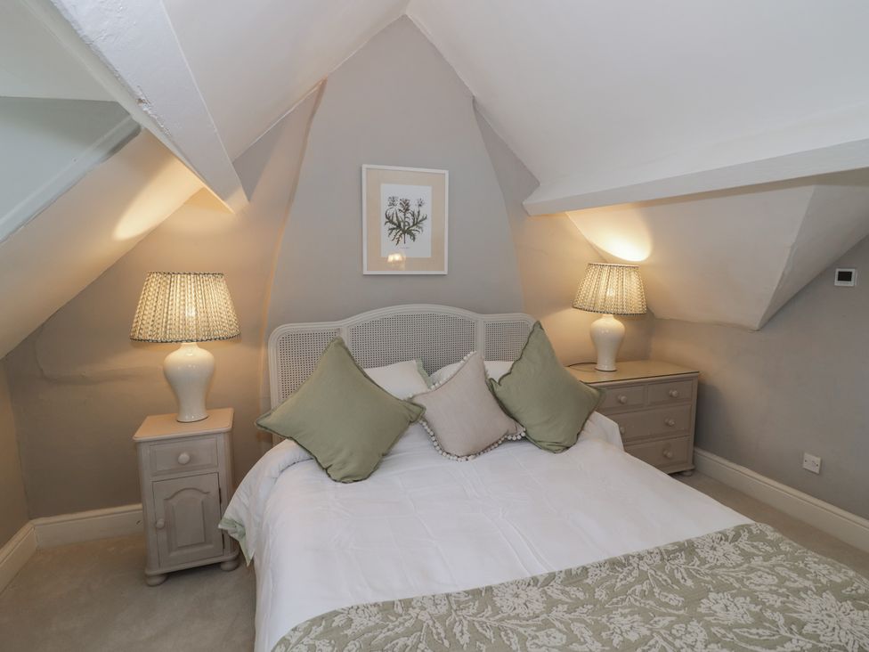 A bedroom with a bed and nightstands at 23 New Church Street Tetbury