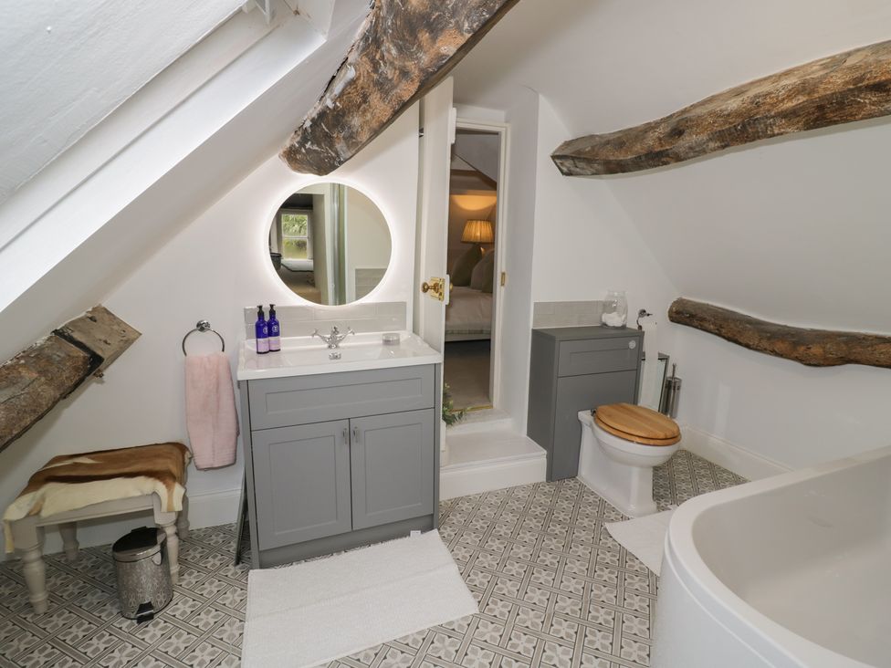 A bathroom with a bathtub and sink at 23 New Church Street Tetbury