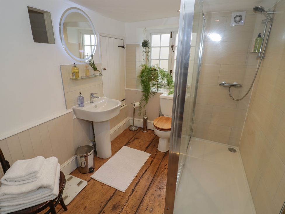 A bathroom with sink, toilet, and shower at 23 New Church Street in Tetbury