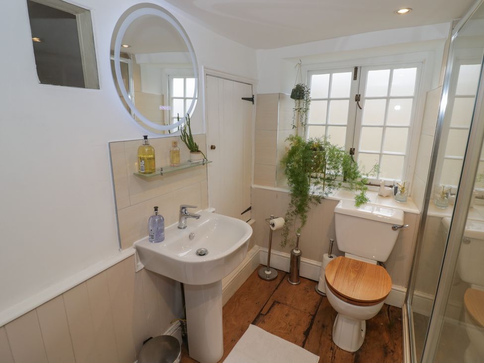 A bathroom with a sink, toilet, and shower at 23 New Church Street in Tetbury