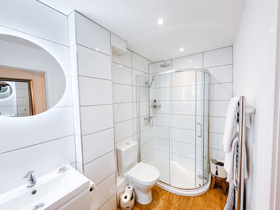 A bathroom with a shower, toilet, and sink at Ammil Bespoke 