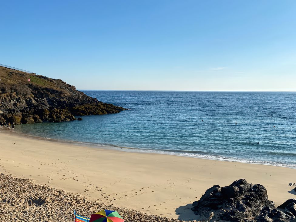 A beach with sand and water at Ammil Bespoke