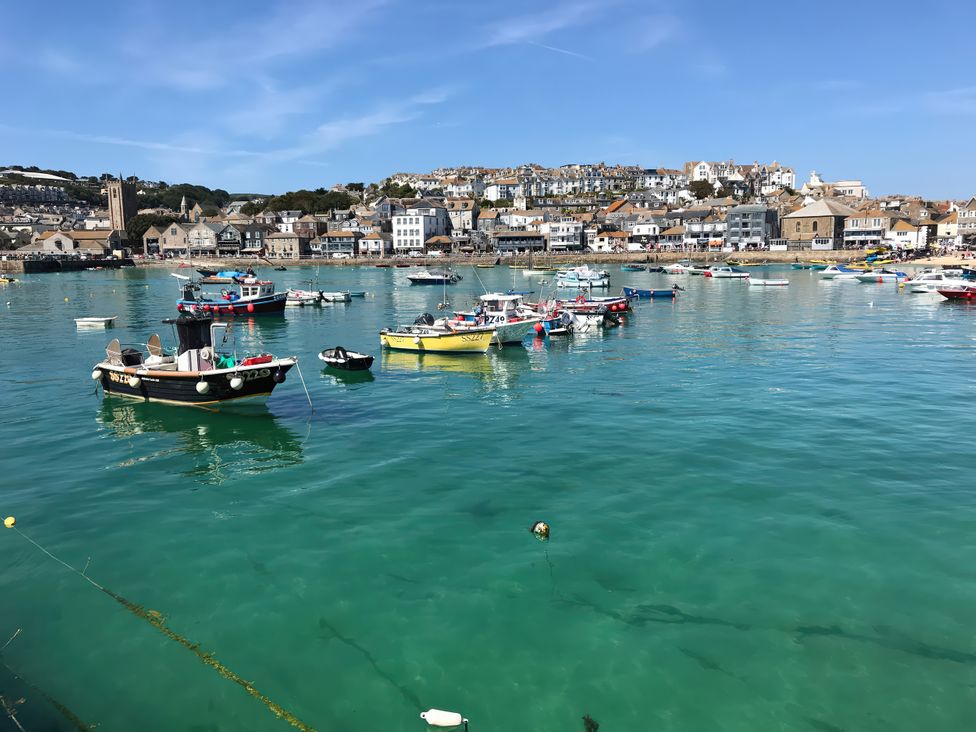 Boats in the water at a harbor with buildings in the background