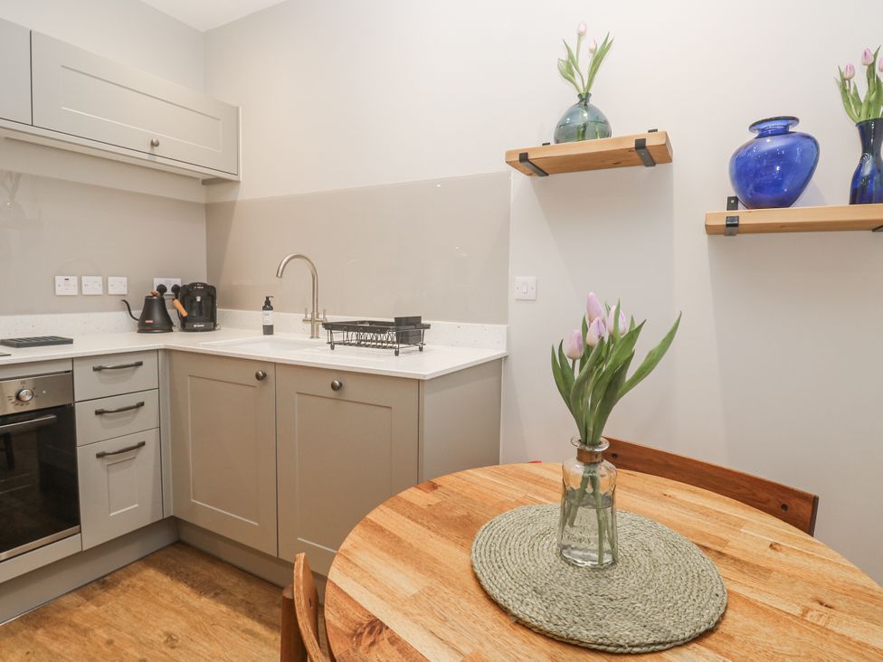 A kitchen with a table and vase at Ammil Bespoke in St Ives