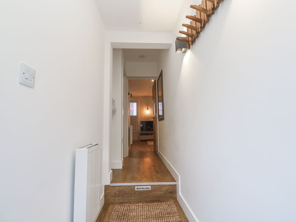 A hallway with a staircase and a radiator at Ammil Bespoke in St Ives