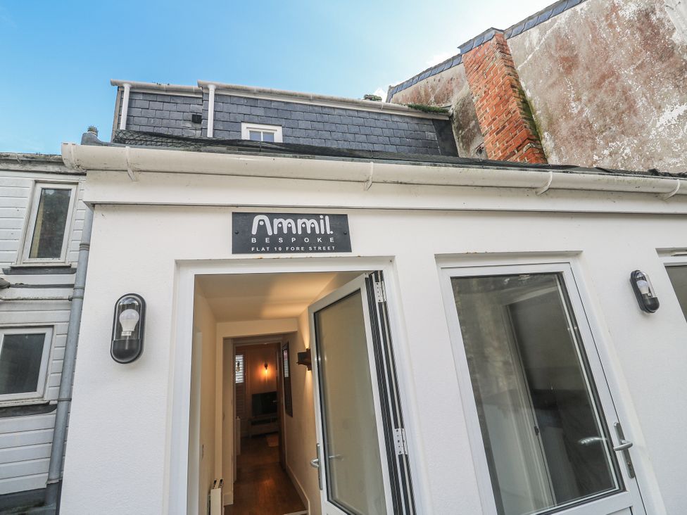 An entrance with a sign and light fixture at Ammil Bespoke in St Ives